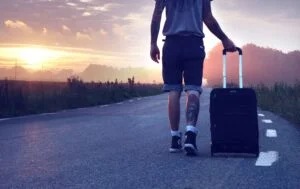 Man with luggage on road